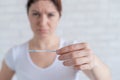 Sad woman shows a negative ovulation test. The concept of female infertility and low luteinizing hormone. Frustrated