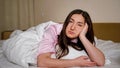 Sad woman sighs deeply lying on king size bed lonely Royalty Free Stock Photo