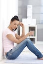 Sad woman sitting on floor at home Royalty Free Stock Photo