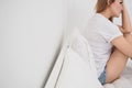 Sad woman sitting on white the bed at bedroom. Royalty Free Stock Photo