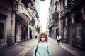 Sad woman stand in the. middle of the road in the city wearing protection coronavirus mask - concept of lockdown and economy