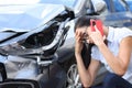 Sad woman talking on cell phone near broken car Royalty Free Stock Photo