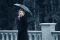 Sad young fashion woman with umbrella walking outdoor Royalty Free Stock Photo