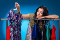 Sad Woman Under The Clothing Rack With Dresses