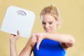 Sad woman with weight gain thumb down sign Royalty Free Stock Photo