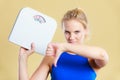 Sad woman with weight gain thumb down sign Royalty Free Stock Photo