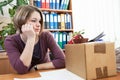 Sad woman in workplace after dismissal Royalty Free Stock Photo