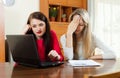 Sad women with financial documents and laptop