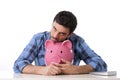 Sad worried man in stress with empty piggy bank Royalty Free Stock Photo