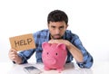 Sad worried man in stress with piggy bank in bad f