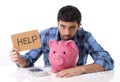 Sad worried man in stress with piggy bank in bad financial situation Royalty Free Stock Photo