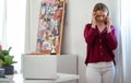 Sad and worried young girl with telephone indoors, internet abuse concept.