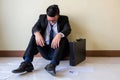 Sad Asian businessman sit on floor Royalty Free Stock Photo