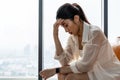 Sad young asian woman sit alone feel depressed lonely. Upset single lady thinking of health problem divorce solitude. Royalty Free Stock Photo