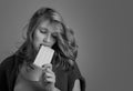 Sad young beautiful woman eating white chocolate Royalty Free Stock Photo