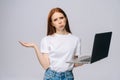 Sad young business woman or student holding keeping opened laptop computer and looking at camera Royalty Free Stock Photo