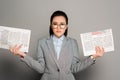 Young businesswoman in eyeglasses holding newspapers Royalty Free Stock Photo