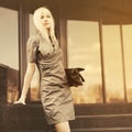 Sad young fashion business woman with handbag at office building Royalty Free Stock Photo