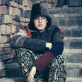 Sad young fashion hipster man sitting on the steps Royalty Free Stock Photo