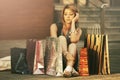 Sad young fashion woman with shopping bags sitting on sidewalk Royalty Free Stock Photo