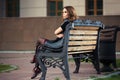 Sad young fashion woman sitting on bench Royalty Free Stock Photo