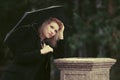 Sad young fashion woman with umbrella in the rain Royalty Free Stock Photo