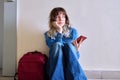 Sad young female student with backpack smartphone sitting on the floor Royalty Free Stock Photo