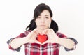 Sad young girl holding a small red heart and her fingers in the form of heart. Royalty Free Stock Photo