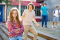 Sad young girl offended by her friends near school outdoors Royalty Free Stock Photo