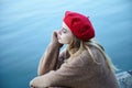 Sad young girl sitting on the pier, thoughtful, lonely Royalty Free Stock Photo