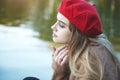 Sad young girl sitting on the pier, thoughtful, lonely Royalty Free Stock Photo