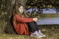 Sad young girl by tree Royalty Free Stock Photo