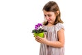 Sad young little girl holding flower pot mourning family loss Royalty Free Stock Photo