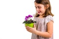 Sad young little girl holding flower pot mourning family loss Royalty Free Stock Photo