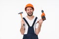 Sad young man holding drill and hammer Royalty Free Stock Photo