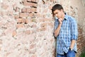 Sad young man near the brick wall Royalty Free Stock Photo