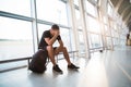 Sad young man waiting for delayed flight in airport Royalty Free Stock Photo