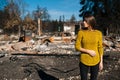 Woman in front of her burned home after fire disaster Royalty Free Stock Photo