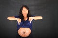 Sad pregnant woman with thumbs down