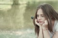 Sad young, teen age girl. Close up portrait of woman meditating. Outdoor scene. Copy space Royalty Free Stock Photo