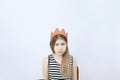 Sad young teenager girl in red crown