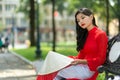 Sad young Vietnamese woman sitting on a bench Royalty Free Stock Photo