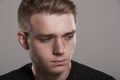 Sad young white man looking away, head and shoulders Royalty Free Stock Photo