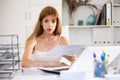 Sad woman bookkeeper doing paperwork in office Royalty Free Stock Photo