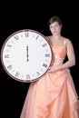 Sad young woman in gown holding a midnight clock