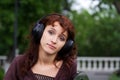 Sad young woman listening to music. Royalty Free Stock Photo