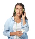 Sad young woman listening to music on white background Royalty Free Stock Photo