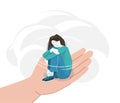 Sad young woman with lowered head hugging herself with her hands on her knees. Anxiety girl sitting on a helping hand Royalty Free Stock Photo