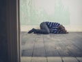 Sad young woman lying on floor Royalty Free Stock Photo