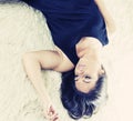 Sad young woman lying on a rug Royalty Free Stock Photo